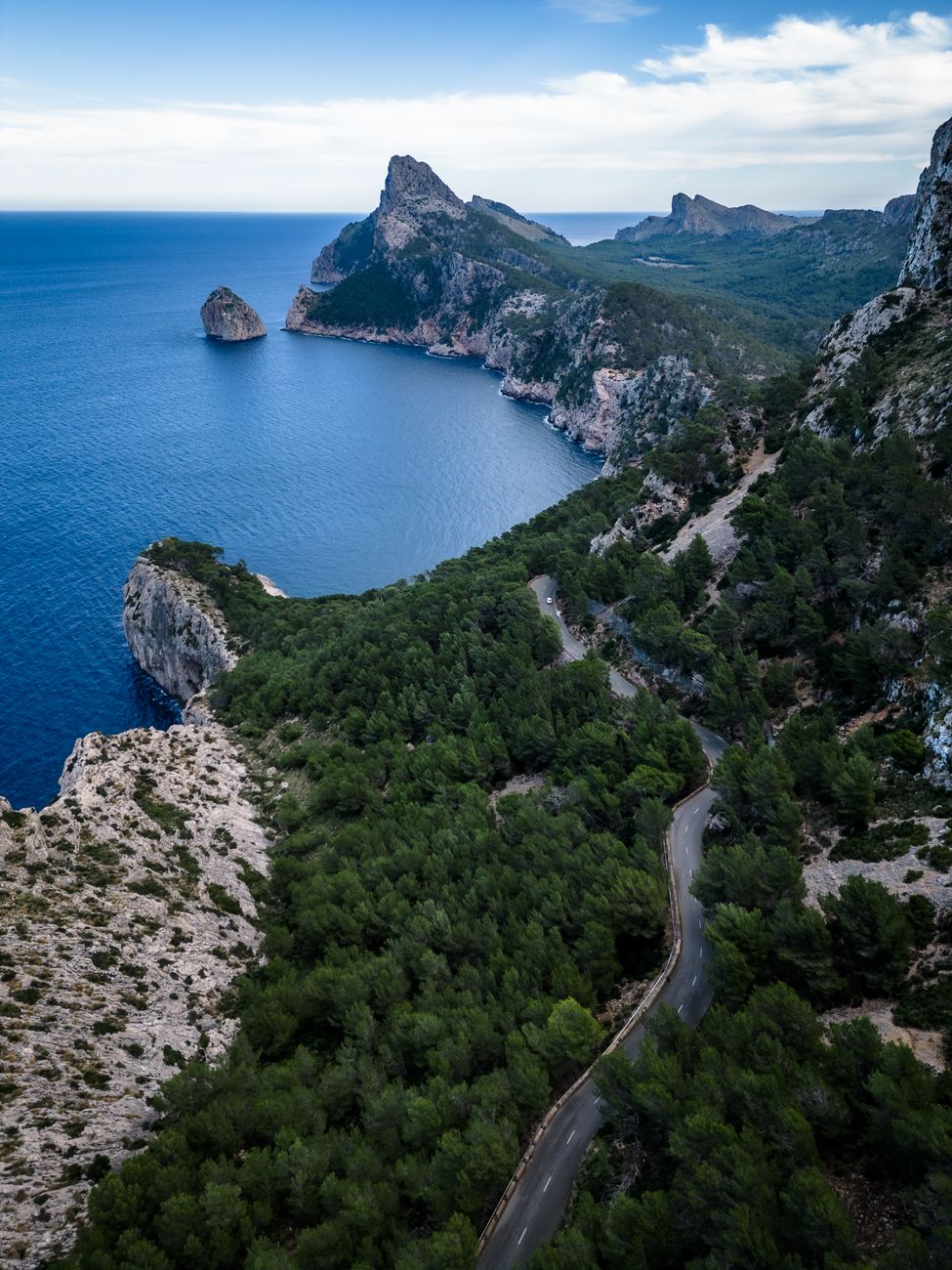 A rental car parked near the rocky coastal roads of Mallorca